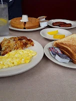 Scrambled Eggs Hash Brown Potatoes Sausage Waffle and Scrapple